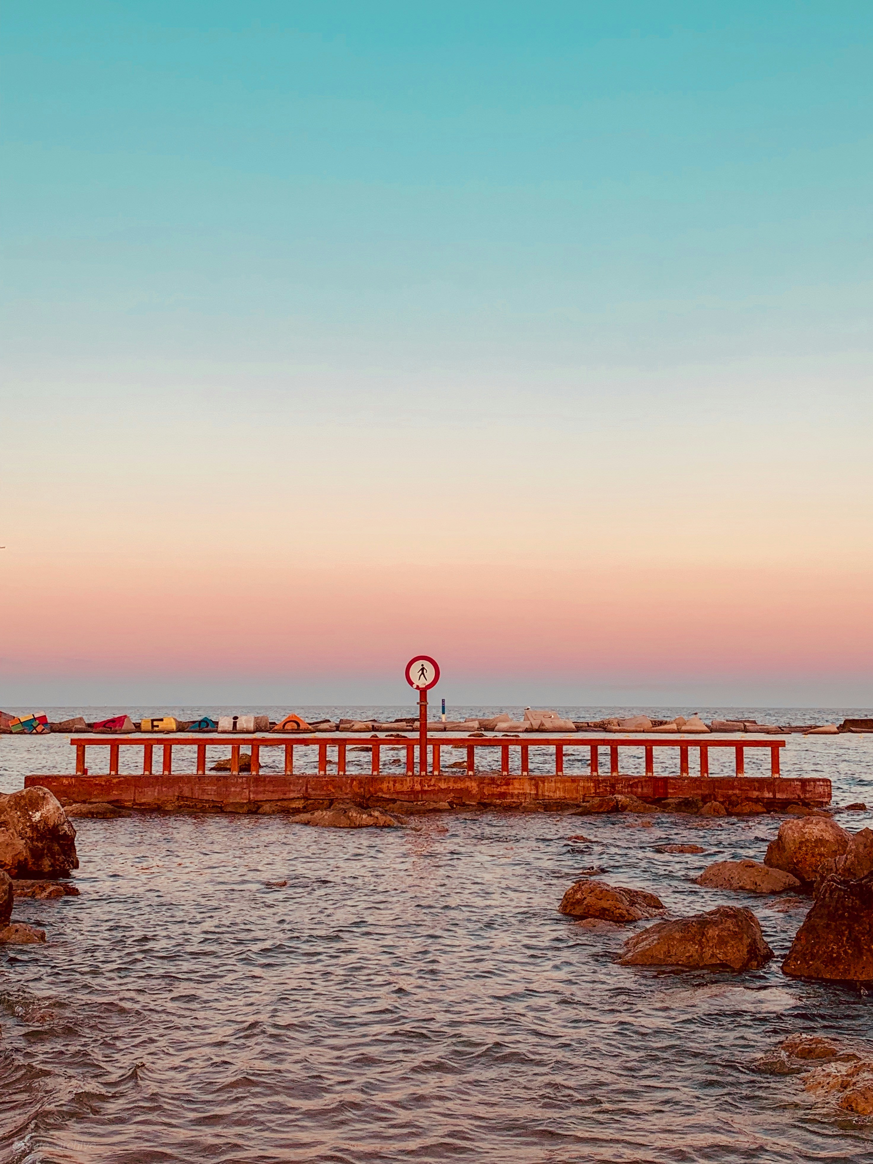 brown rock formation on body of water during daytime