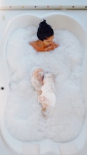 photography of woman on bathtub covered with white bubbles