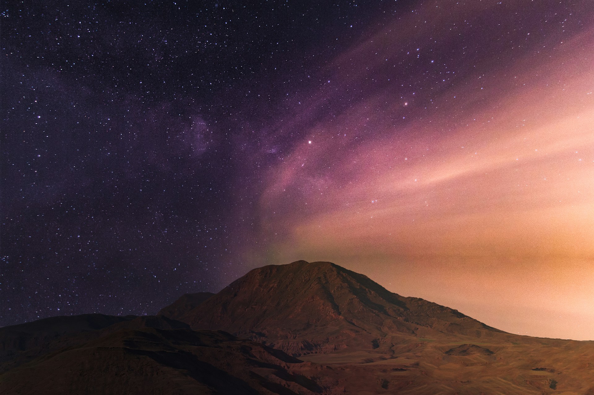 purple starry night sky over the mountain