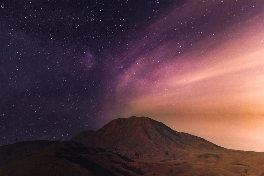 purple starry night sky over the mountain