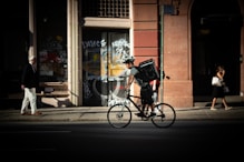 man riding bicycle near road during daytime