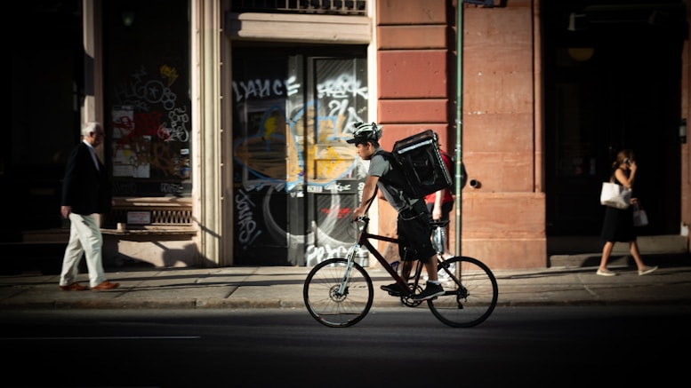 man riding bicycle near road during daytime