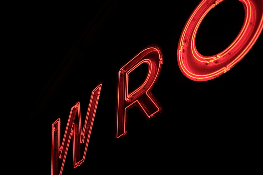 a close up of a neon sign on the side of a building