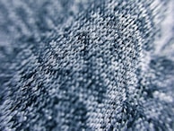 Close-up of textured thread layers creating a 3D effect in embroidery.
