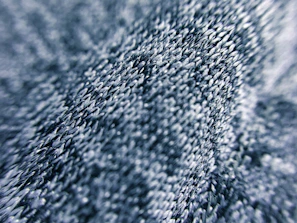 Close-up of a navy blue fabric texture with subtle stitching details