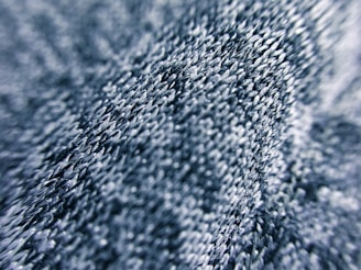 A close-up shot of a vibrant blue fabric with intricate stitching details.