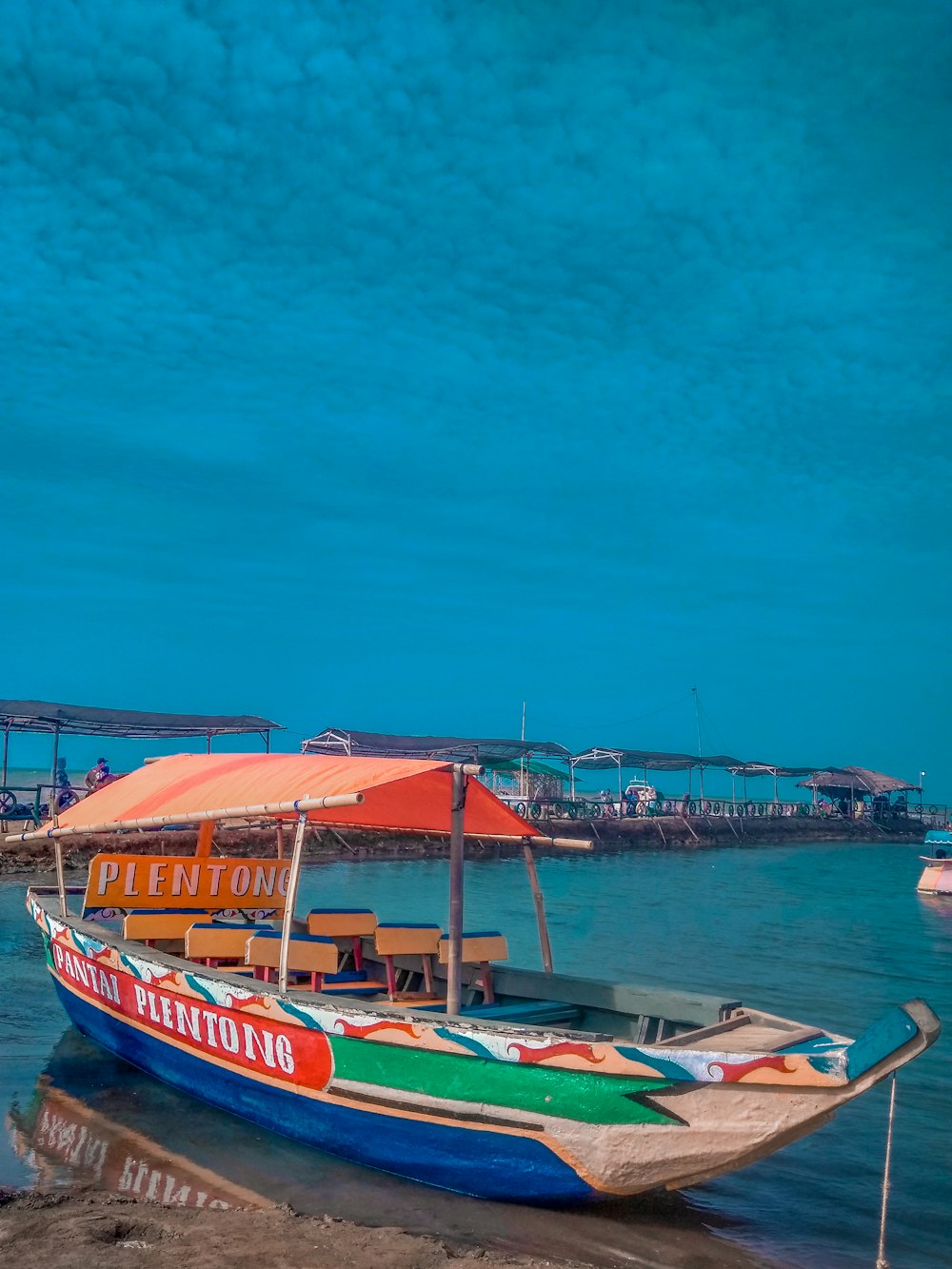 brown and blue boat on water