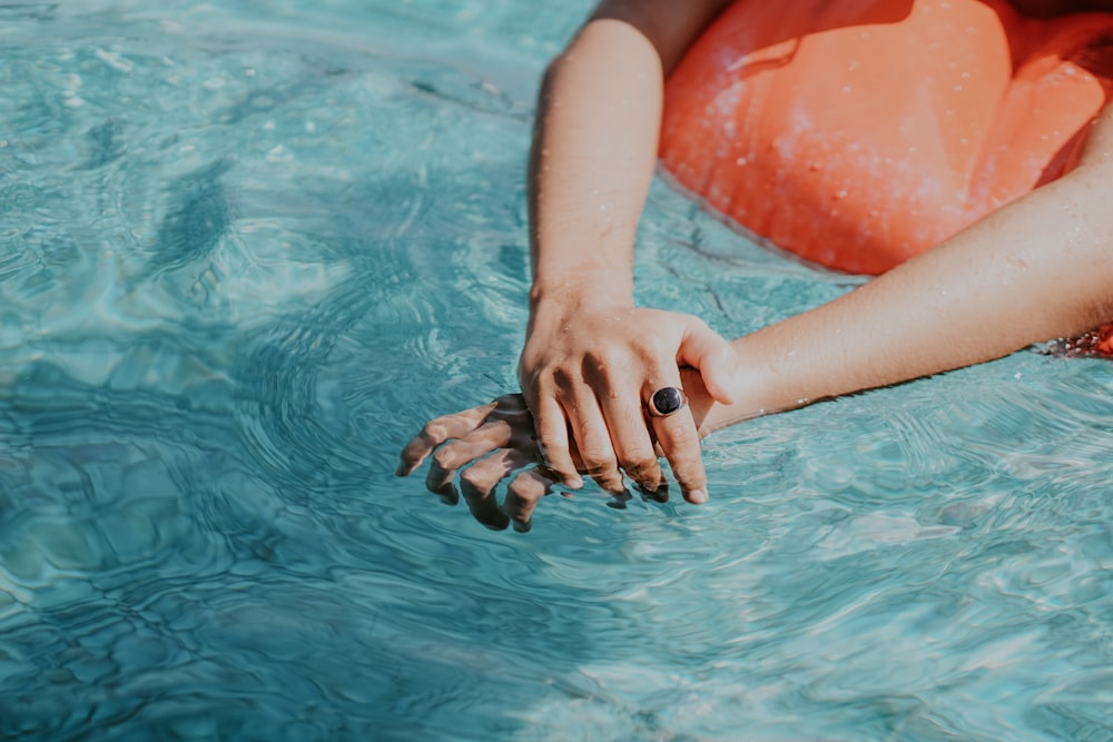 person lying on red inflatable