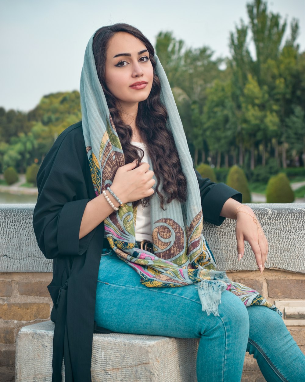 woman wearing black cardigan and blue denim jeans