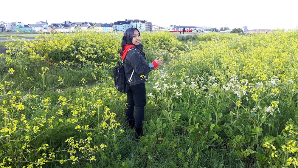 woman standing near flowers