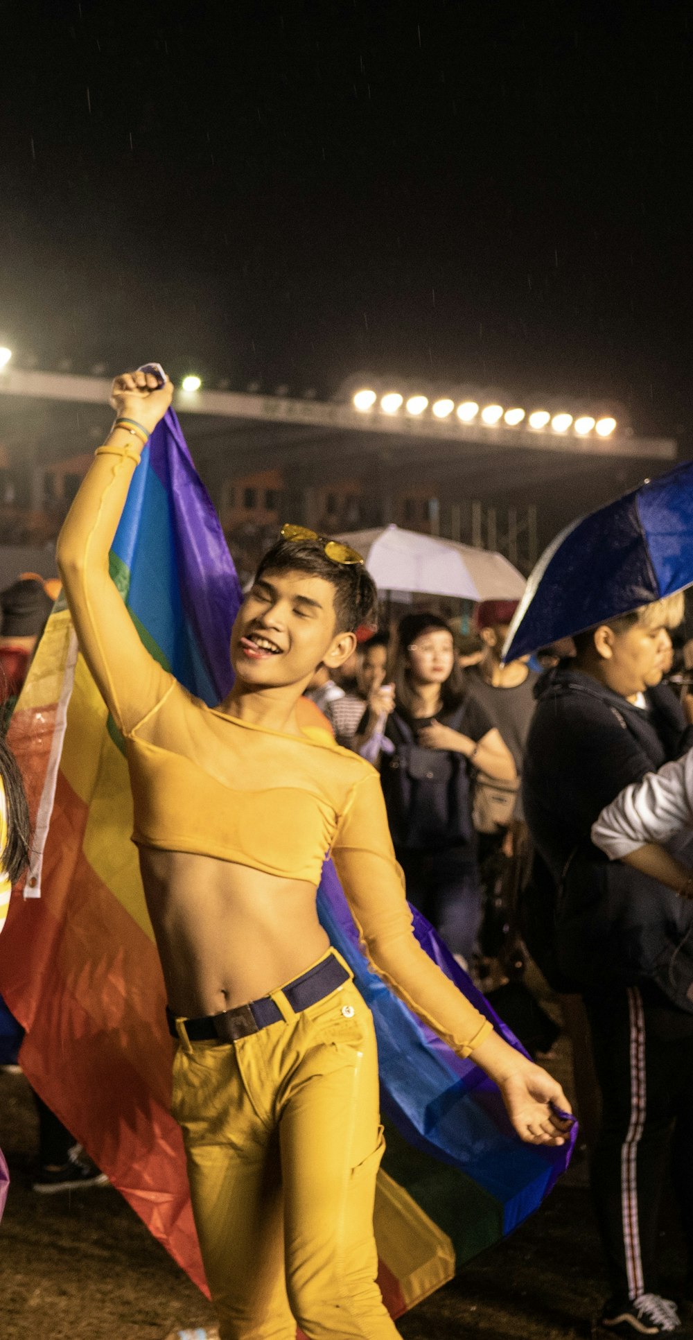 man holding LGBT flag