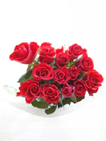 Close-up of a vibrant red rose bouquet against a clean white background.