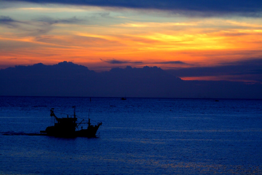 silhouette of boat during golden hour