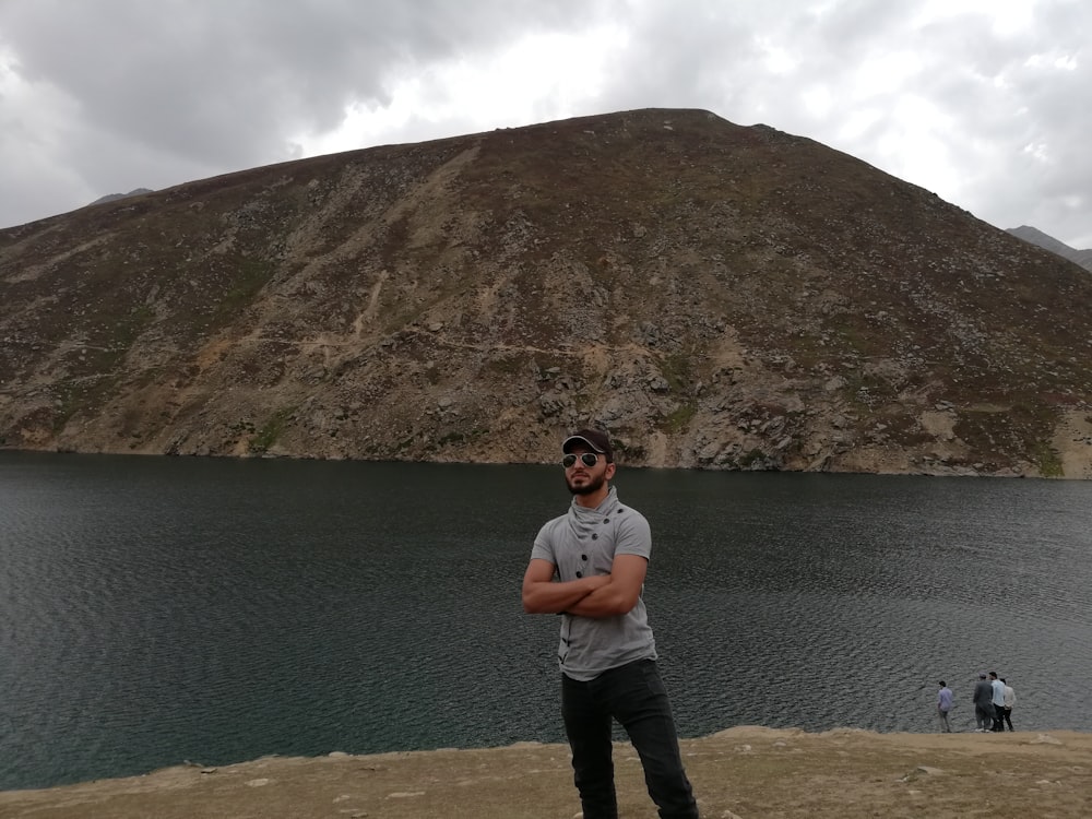 man standing near lake