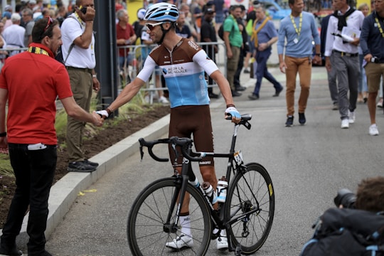 An athlete shaking hands with a brand representative in a vibrant sports event setting.