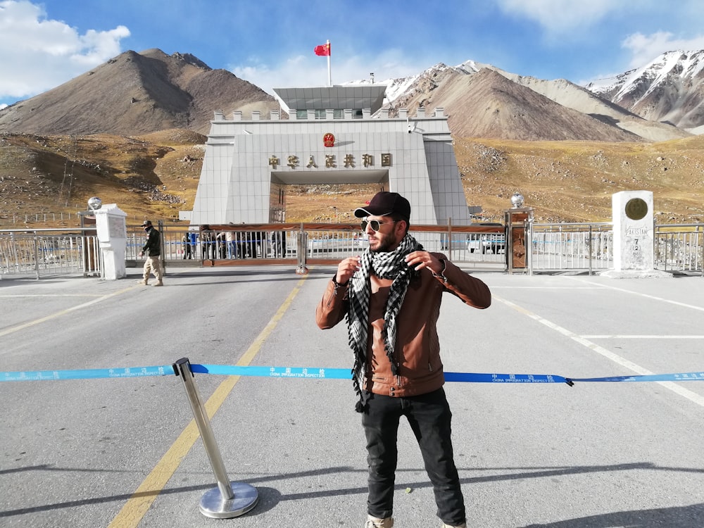 man standing in front of stanchion