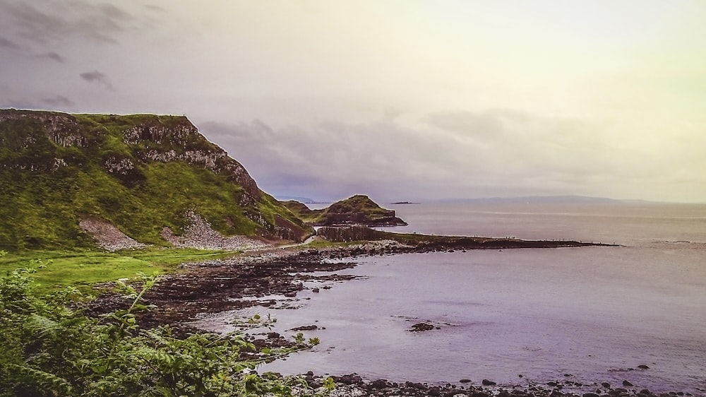 photography of mountain and seashore during daytime