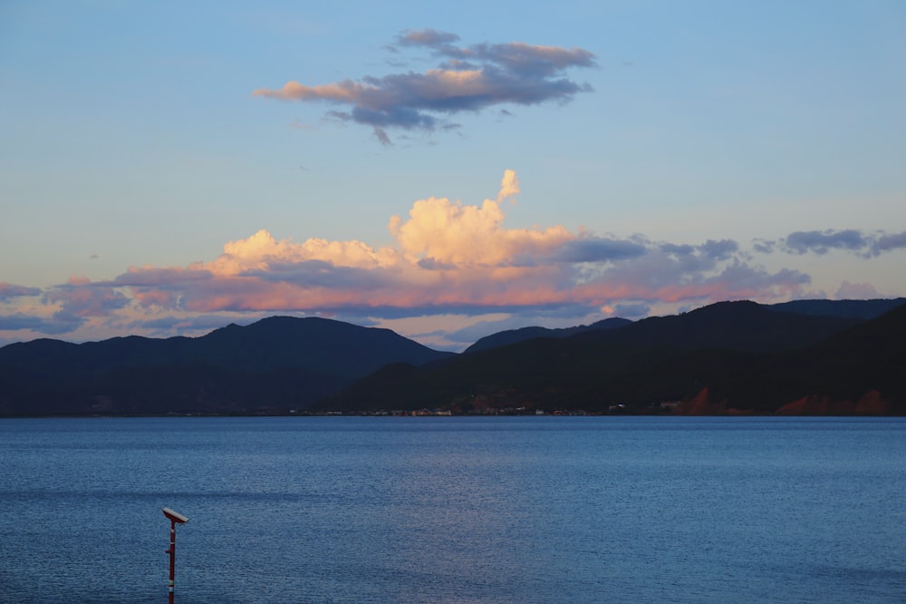 a body of water with mountains in the background