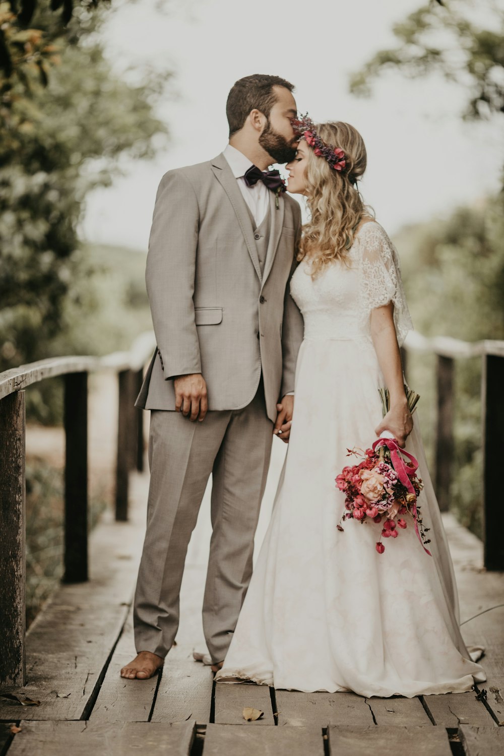 man kissing woman on the forhead