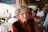 smiling woman in red sweater and black vest