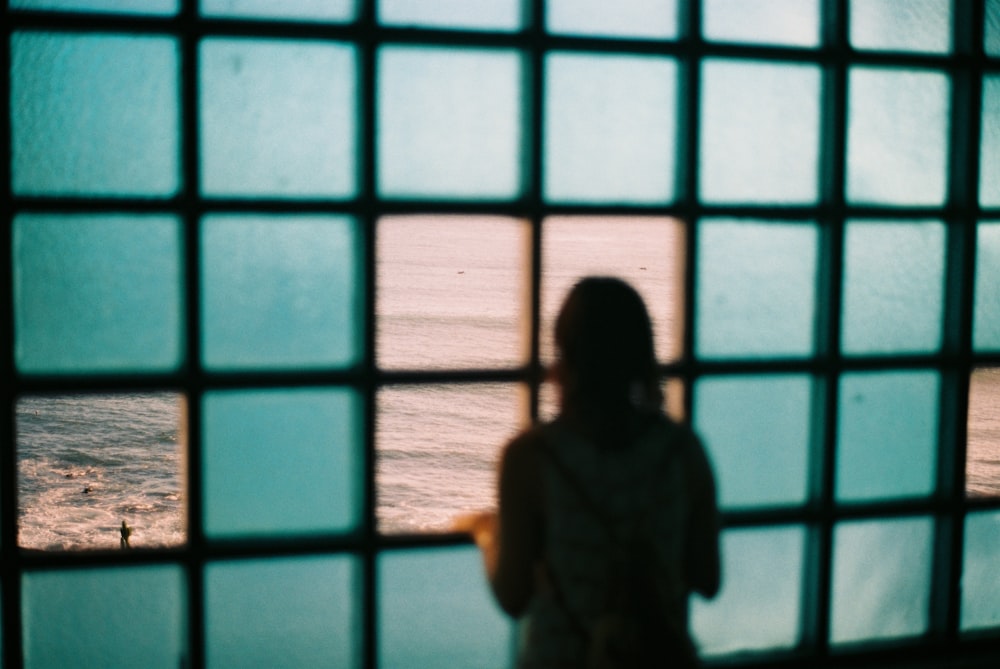 woman peeking through window