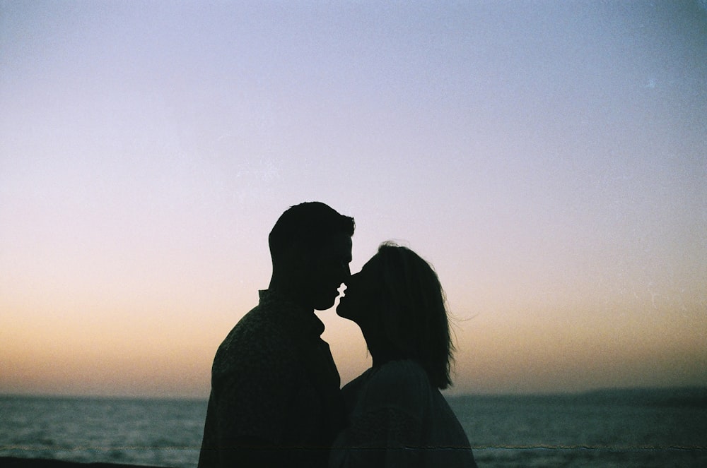 couple near body of water at golden h