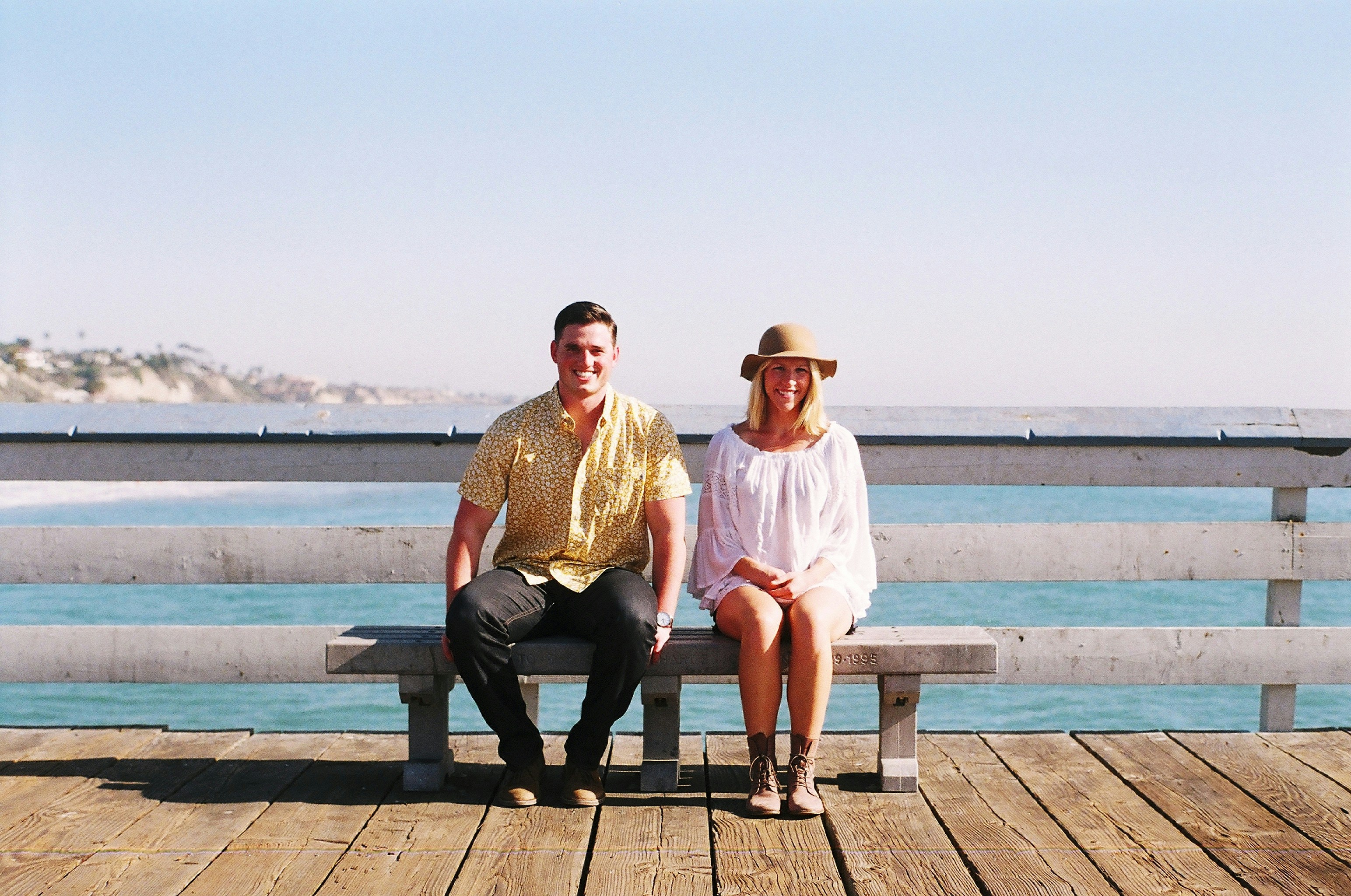 woman sitting on bench beside man