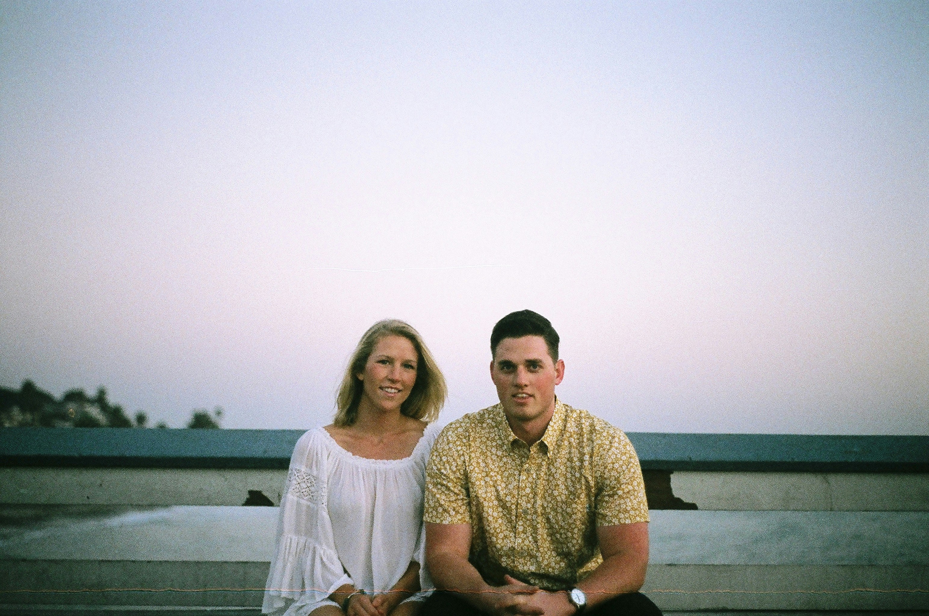 man and woman sitting near wall