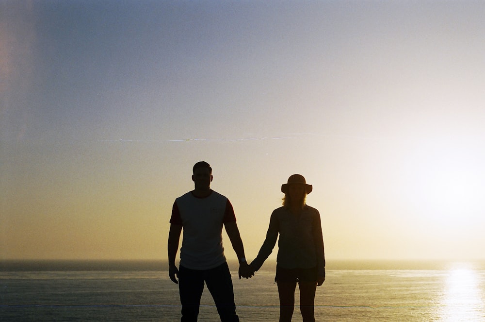 silhouette of couple holding hands