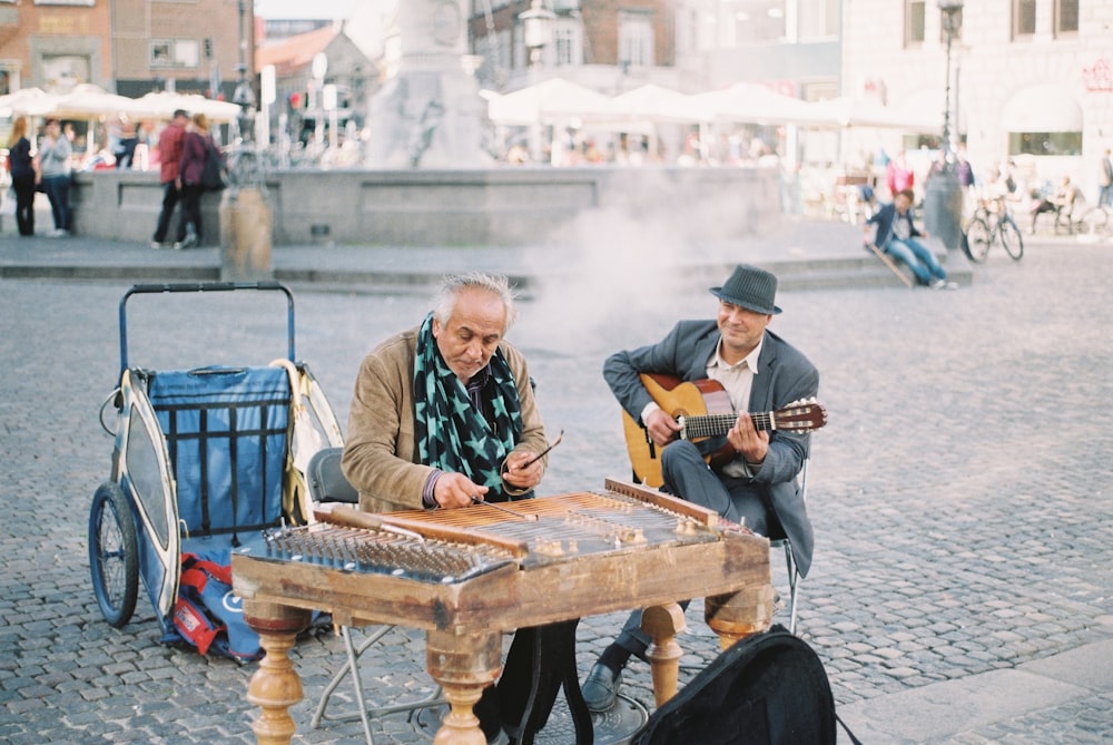 man playing guitar on road