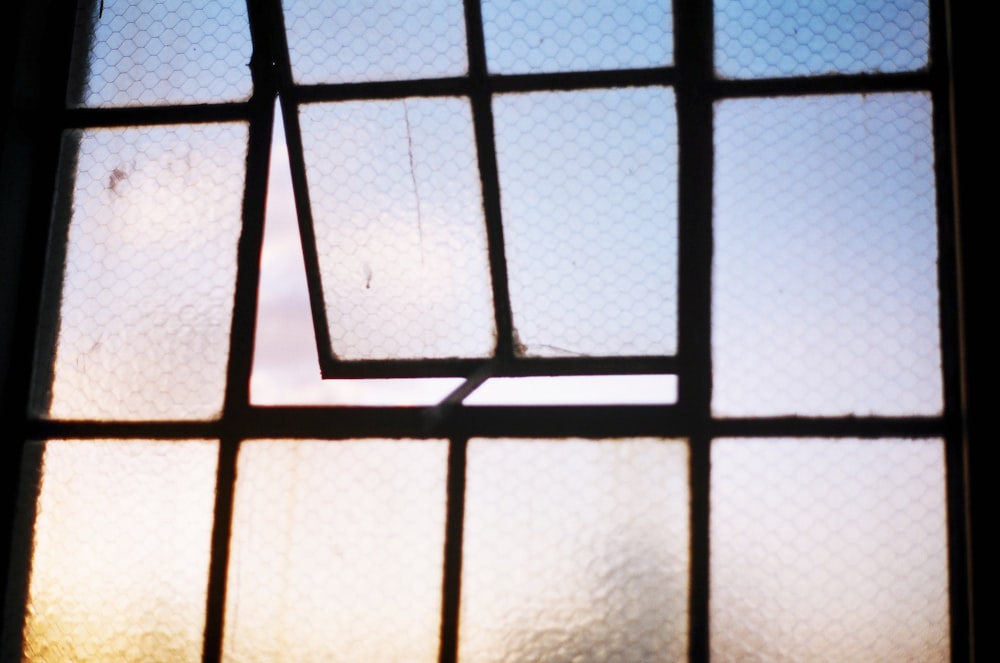 a close up of a window with a sky background