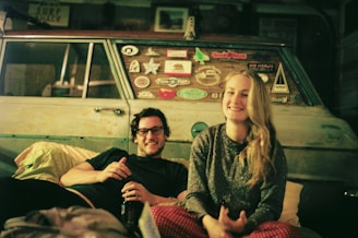 A happy couple smiling inside their newly financed used car in Jerez.