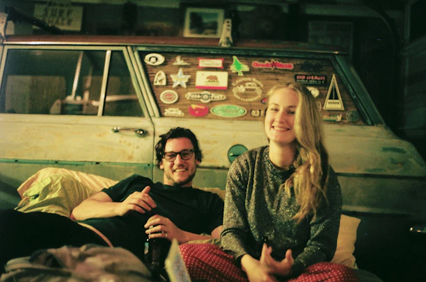 A happy couple boarding a comfortable shuttle bus for their tour.