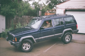 A family SUV parked in a suburban driveway.