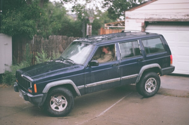A family SUV parked in a suburban driveway.