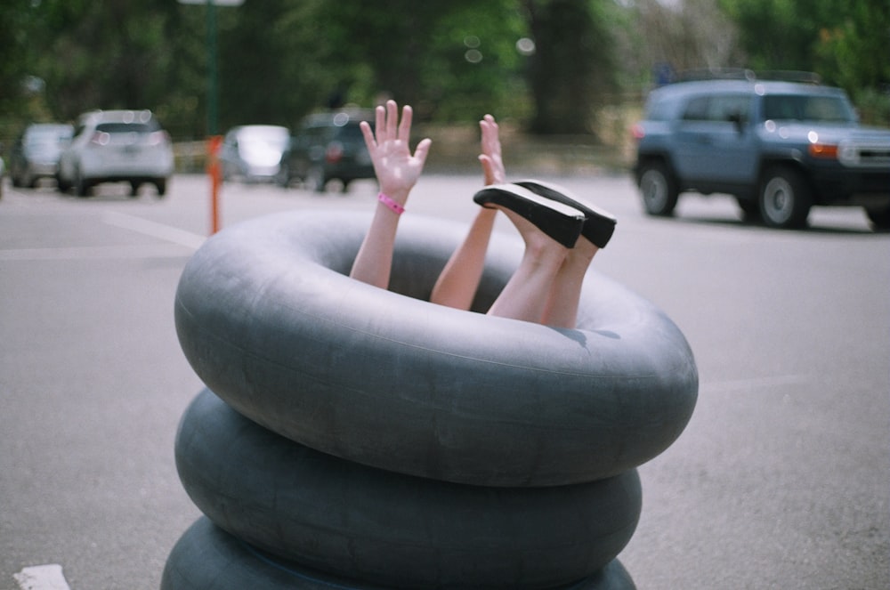 person sitting on inflatable rings