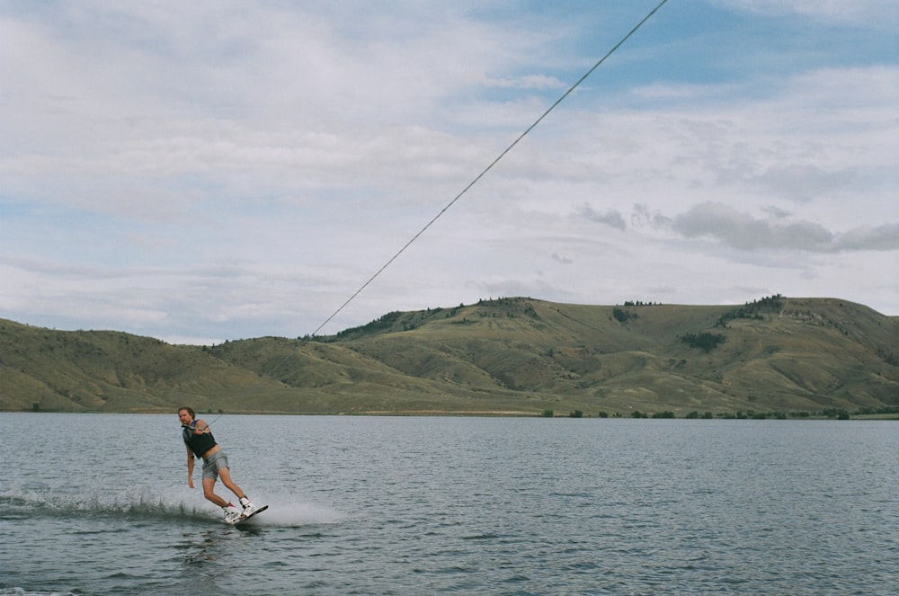 man wakeboarding in lake