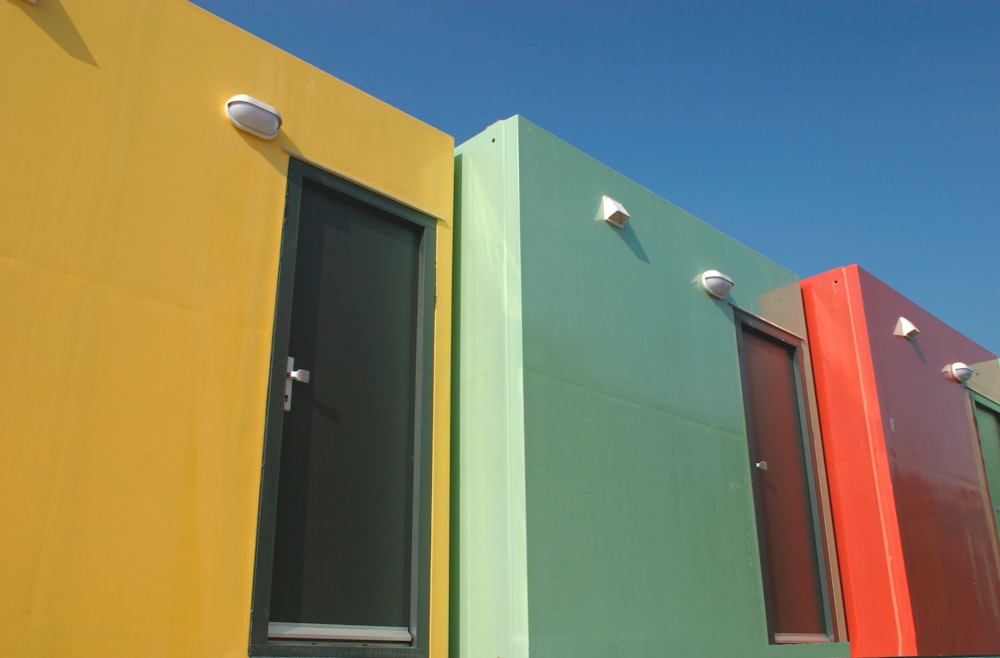 a row of brightly colored buildings with a blue sky in the background