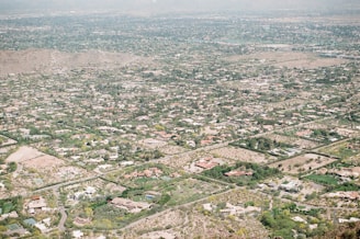 High-resolution aerial shot of a sprawling suburban home with landscaped gardens.