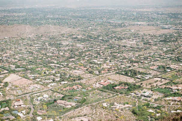 Aerial drone shot showcasing a sprawling suburban home with lush landscaping.