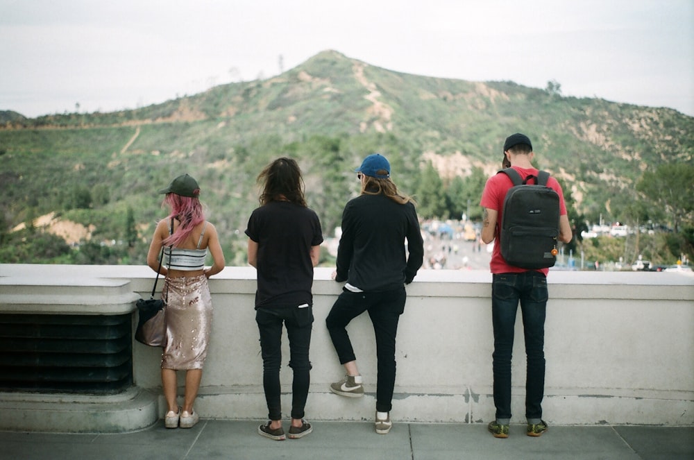 four person standing outdoor during daytime