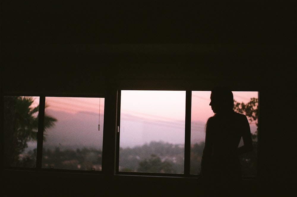 person standing in front of window panel