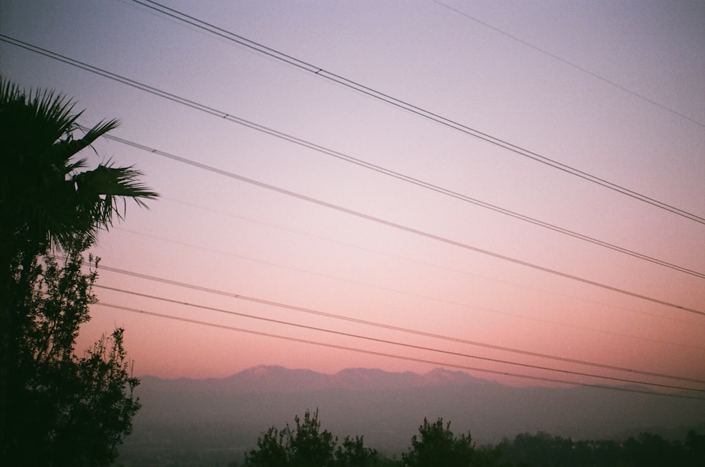 a view of a mountain range with power lines in the foreground