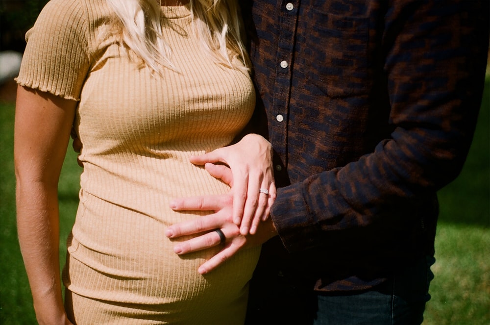 man holding pregnant woman's tummy