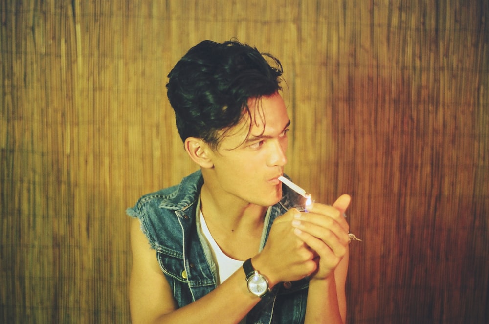selective-focus photography of man smoking cigarette