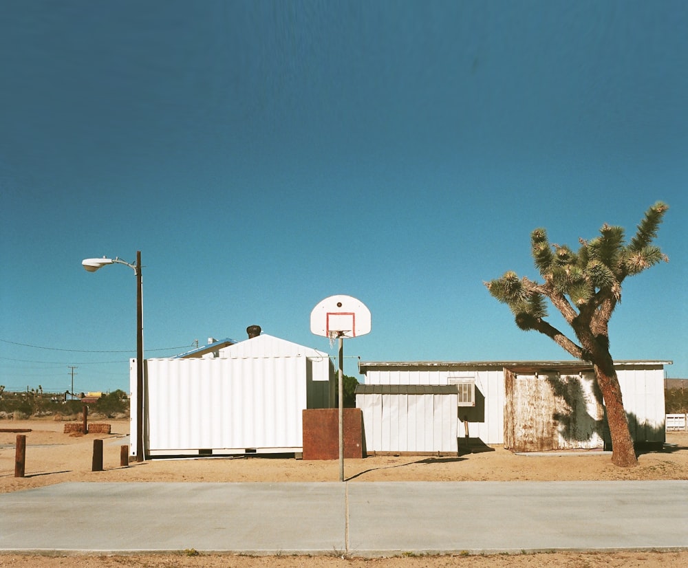 a white building with a basketball hoop in front of it