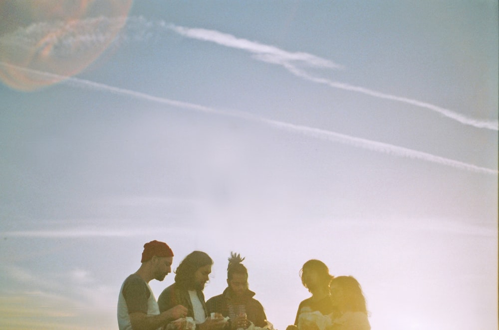 four person sitting during daytime