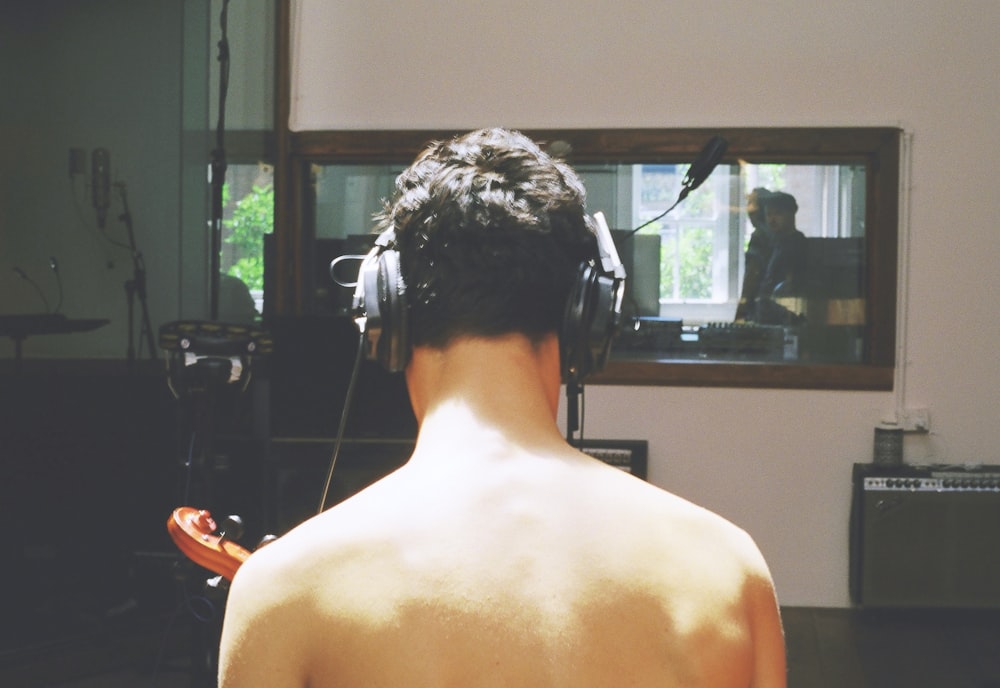 topless man wearing headphones