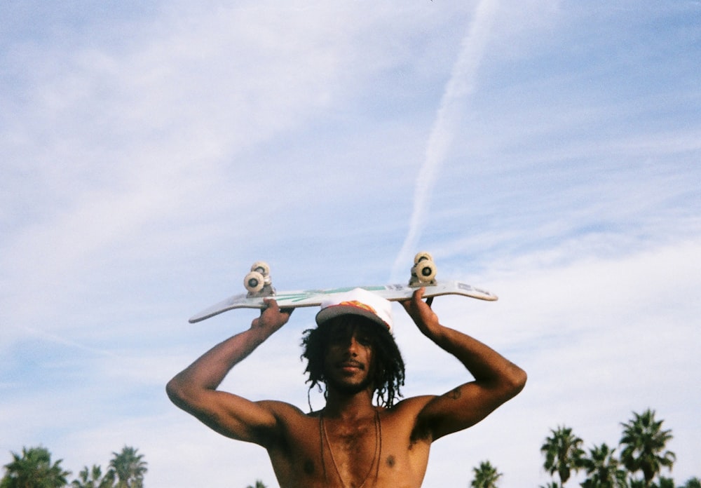 man carrying skateboard