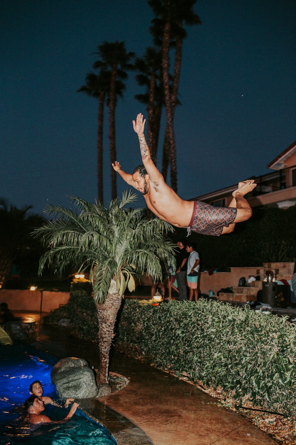 a man is doing a trick in the pool